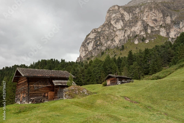 Obraz small house over a mountain pasture in Dolomites with wonderful panorama
