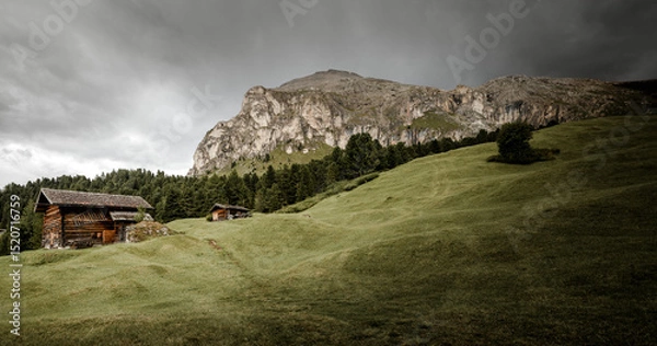 Obraz small house over a mountain pasture in Dolomites with wonderful panorama