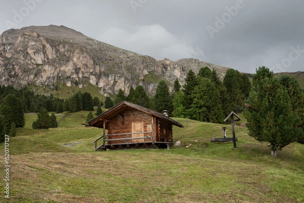 Obraz small house over a mountain pasture in Dolomites with wonderful panorama
