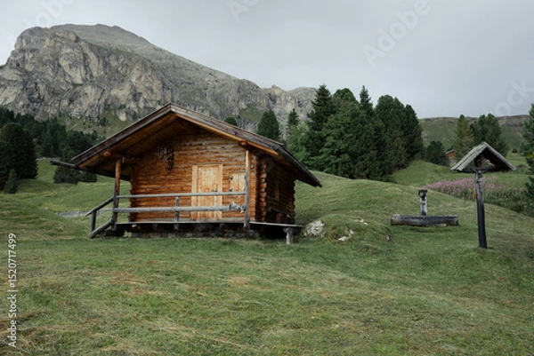 Obraz small house over a mountain pasture in Dolomites with wonderful panorama