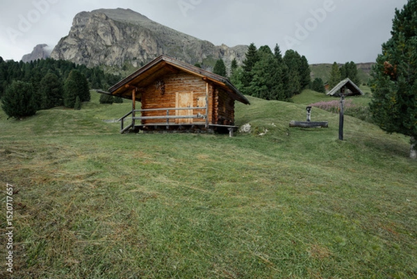 Obraz small house over a mountain pasture in Dolomites with wonderful panorama