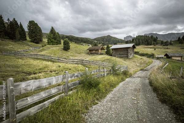 Obraz small house over a mountain pasture in Dolomites with wonderful panorama