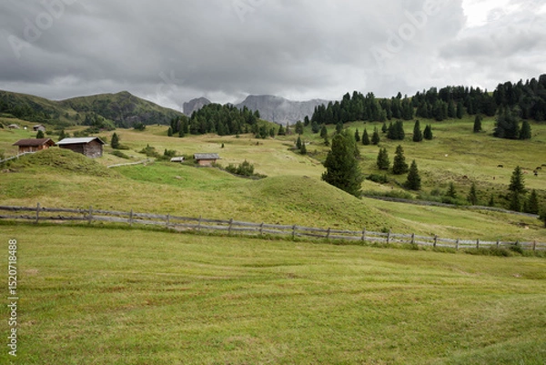Obraz small house over a mountain pasture in Dolomites with wonderful panorama
