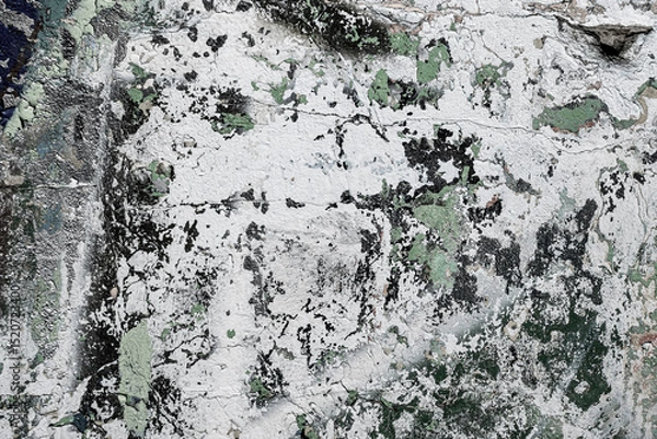 Fototapeta Abstraction of crumbling graffiti on a city street wall. Colorful abstract background. Old, cracked, peeling paint on the wall as a background.Abstract background in neutral calm colors.