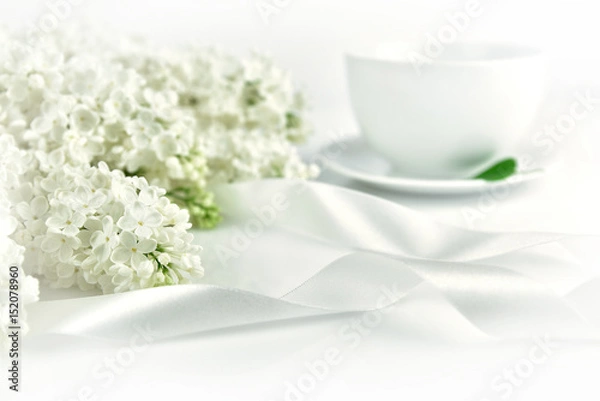 Obraz White lilac with ribbon and cup of tea at the morning