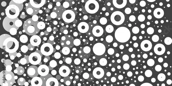 Fototapeta A monochromatic abstract pattern of bright white overlapping circles and rings with varying sizes, forming a textured and dynamic design on a dark background.