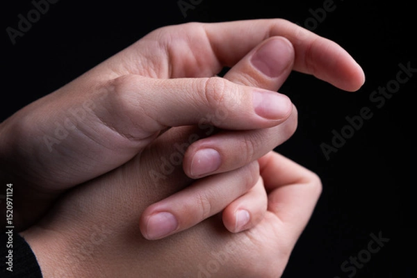 Obraz Close up of woman's hands intertwined together, delicate feminine hands with neat manicure. Support and touching herself