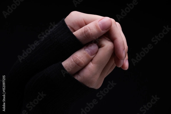 Obraz Female hands on a black background. Concept of tenderness and self-care.