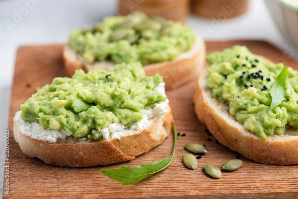 Fototapeta Toast with avocado and seeds, healthy vegan snack
