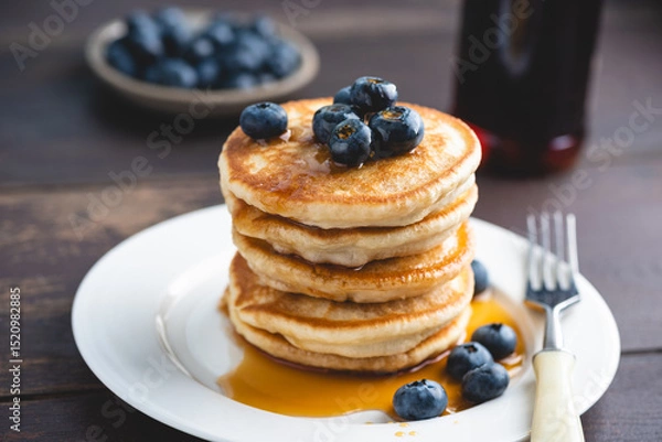 Fototapeta Stack of fluffy buttermilk pancakes with maple syrup and blueberries