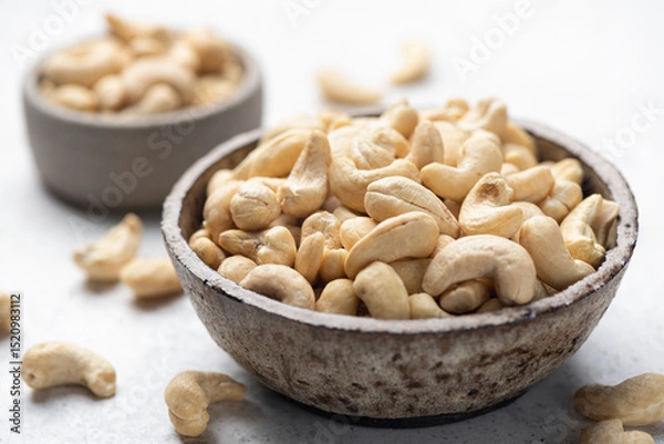 Fototapeta Dry cashews in a bowl closeup view