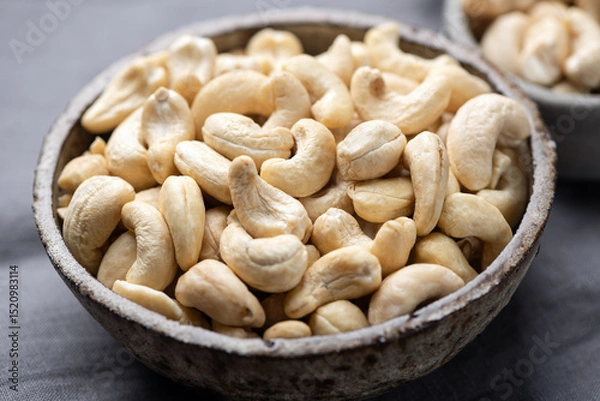 Fototapeta Dry cashews in a bowl closeup view
