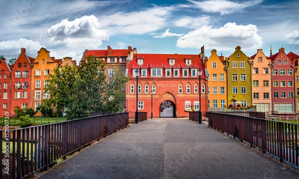Obraz Attractive morning cityscape of Gdansk town with old colorful buildings, Poland, Europe. Colorful summer scene of Cow Bridge to old town. Traveling concept background.