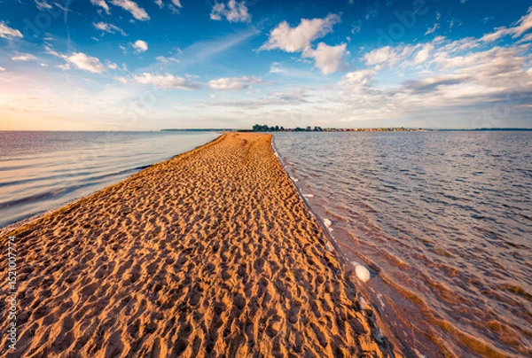 Obraz Wonderful summer sunrise on Baltic sea with the end of the sand spit with a lots of footsteps. Amazing endless clouds  in blue sky. Picturesque morning scene of Rewa public beach, Poland, Europe.
