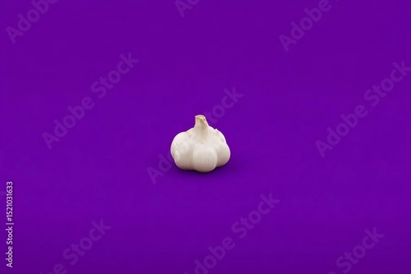 Fototapeta Garlic isolated against a purple background