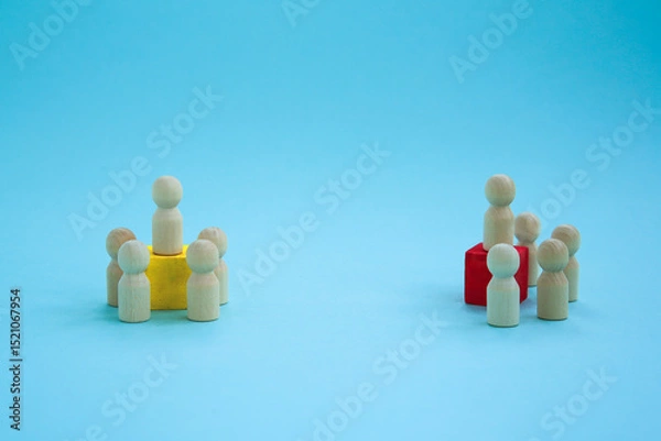 Obraz Groups and associations with leaders. Wooden figures with a red and yellow cube for the leader on a blue background. . political parties,
