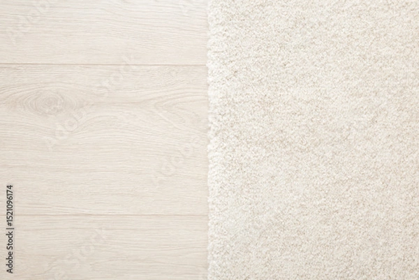 Fototapeta White new fluffy home carpet on light color laminate background. Closeup. Two sides. Top down view.