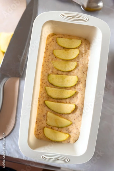 Obraz Apple Pie Batter with Sliced Apples in Baking Pan for Homemade Dessert.
