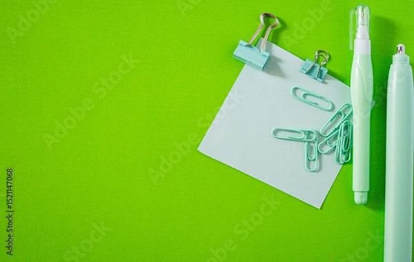 Obraz Flat lay of vibrant school supplies like sticky note and pens on a brightly colored background.