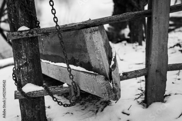 Fototapeta Wooden Boat on the River Bank in the Village in Winter