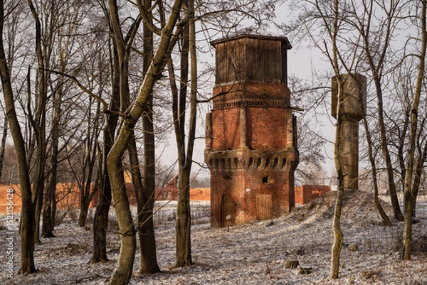 Fototapeta Old brick Tower in the Park in snowy Winter