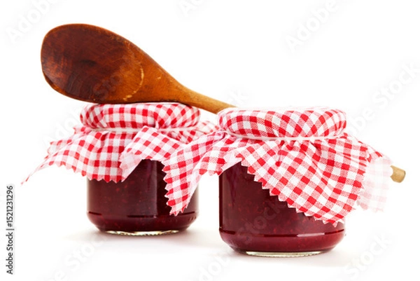 Fototapeta Two jars of homemade jam and wooden cooking spoon isolated on white background