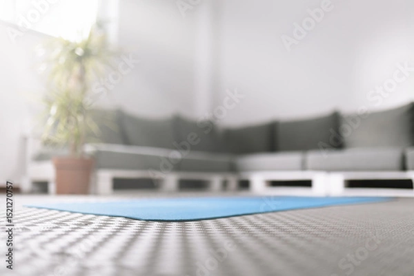Obraz Calm indoor yoga space with a blue mat ready for practice on a serene afternoon