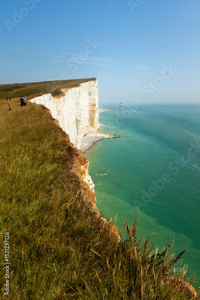 Fototapeta Tourists on the edge of Beachy Head cliff on the English Channel coast, East Sussex, UK