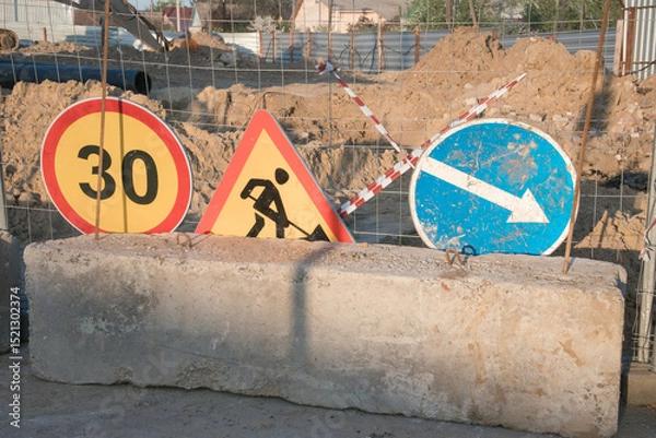 Fototapeta Traffic signs indicating construction zone with speed limit and directions near a road work site