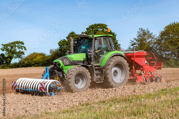 Fototapeta Tractor with seed drill, rotary harrow, and front packer tilling the field - 3561