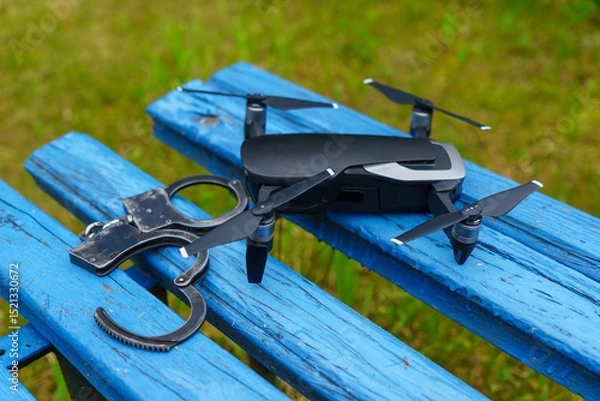 Obraz Remote-controlled drone with handcuffs close-up
