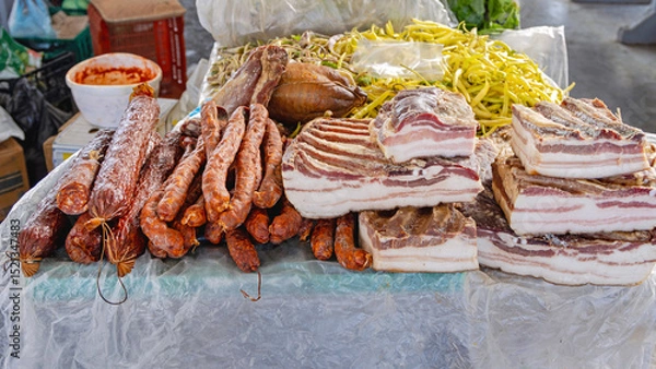 Fototapeta Dry Sausages and Smoked Slabs of Bacon Deli Meat at Farmers Market