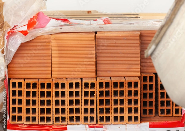 Fototapeta Pallet of hollow bricks ready for building construction