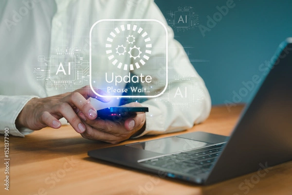 Obraz Man holding smartphone during system update with futuristic AI interface, surrounded by digital elements and laptop on desk. Technology concept of system upgrades and software maintenance.