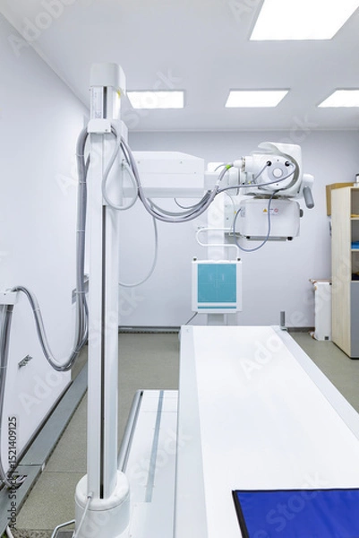 Fototapeta An innovative, multifunctional X-ray diagnostic system, providing high image quality and flexible X-ray examinations, stands in a sterile medical room.
