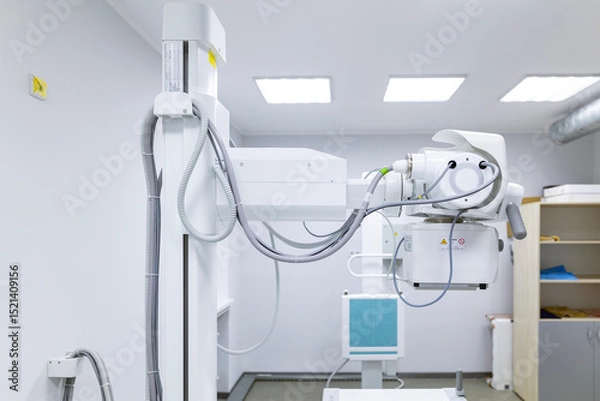 Fototapeta An innovative, multifunctional X-ray diagnostic system, providing high image quality and flexible X-ray examinations, stands in a sterile medical room.