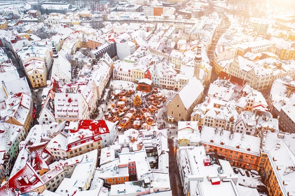 Fototapeta Aerial View of Tallinn with the Town Hall Square in winter, roofs with snow, Christmas mood