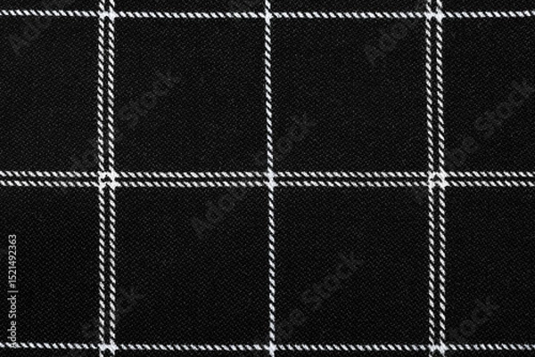 Fototapeta The texture of linen fabric in a large cell of black and white. Scottish tailoring material. checkered fabric