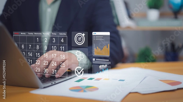Obraz Hand on laptop with digital calendar, target, charts. Symbolizes digital scheduling, project planning, goal setting. Ideal for business management, productivity, data analysis, strategic execution now