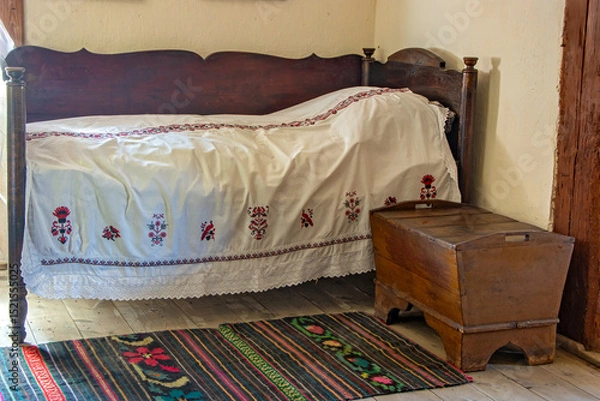 Obraz Old bed with white bedspread in a historic room