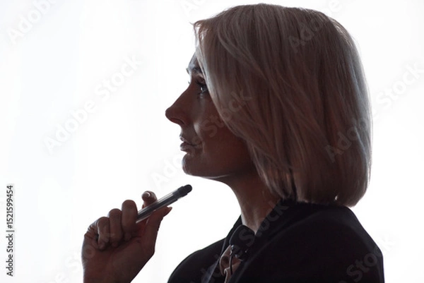 Fototapeta Side view of thoughtful female conference participant actively listening to presenters speech attending lecture on latest AI technology updates captured in auditorium against window