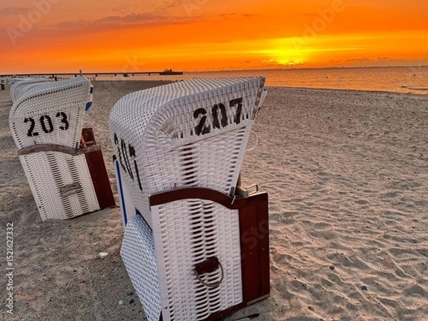 Fototapeta Romantic scene of Beach Chairs at the baltic coastline during sundown in summer