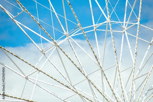 Obraz Close-up of a Ferris wheel with a blue sky in the background 