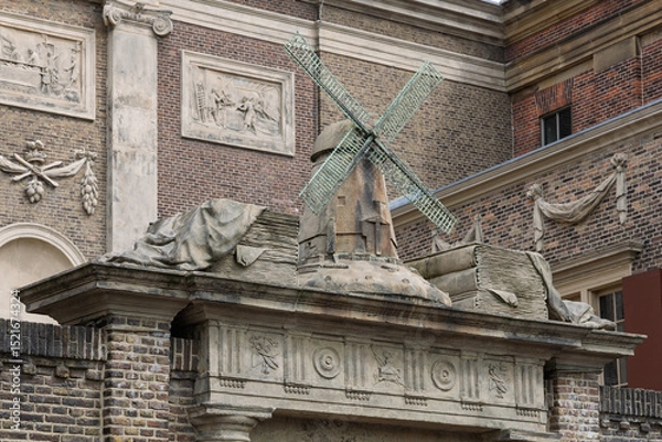 Obraz An architectural detail featuring a miniature windmill on a historic building, the Museum De Lakenhal in Leiden. This heritage highlights Dutch ingenuity. Leiden, Netherlands, 4 May 2025.