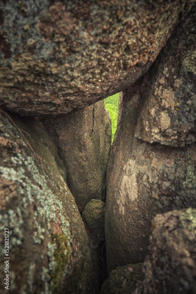 Obraz small hole between huge granite boulders in canyon