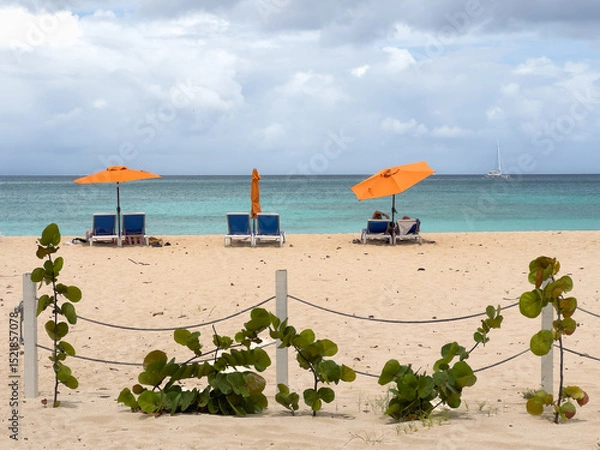 Obraz Lounge chairs on a beach along the ocean