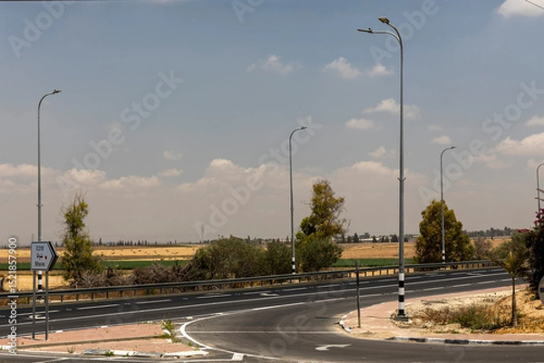 Fototapeta A Rural Road With A Sign For Shuva.
