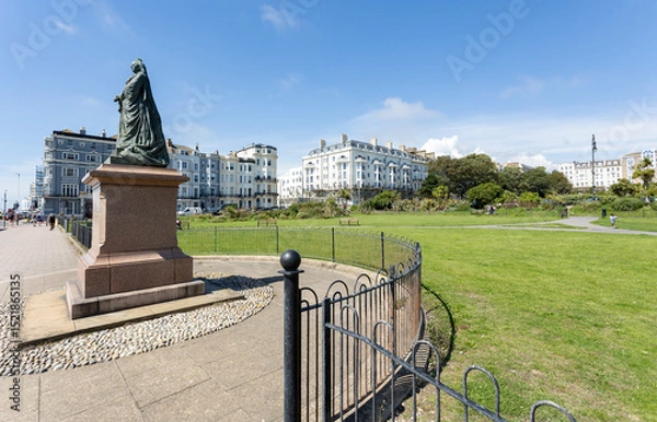Fototapeta St Leonards, East Sussex, England 16, August 2023 Statue of Queen Victoria from 1902 in bronze on a granite pedestal on the seafront at Warrior Square Gardens.