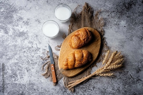Obraz Sesame seeds braided bun on a grey background