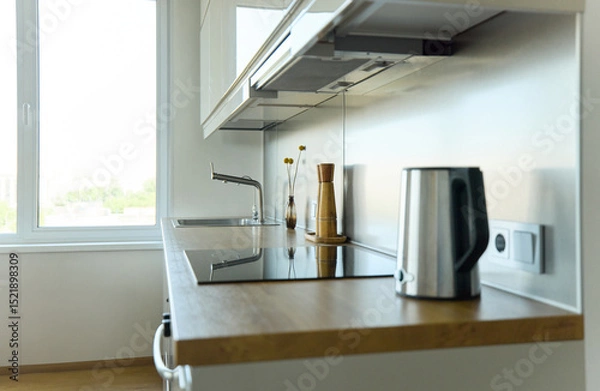Fototapeta A bright kitchen set with a stylish bouquet in a stylish living room, on the surface there is a pepper shaker, a salt shaker and a kettle